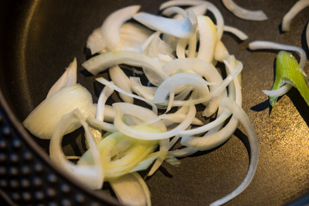 Raw onion in black hot black pan for cooking sukiyaki. Japanese Sukiyakiの写真素材