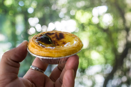 Eggs tart in the hand. Selective focus.の写真素材