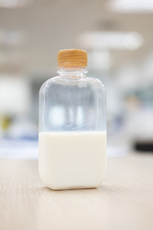 A fresh of milk in plastic bottle with golden lid on wood table