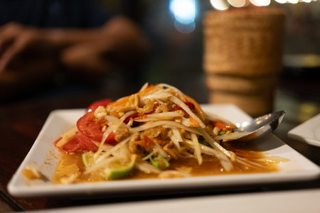 Green papaya salad or Som tam in Thai food at night restraintsの写真素材