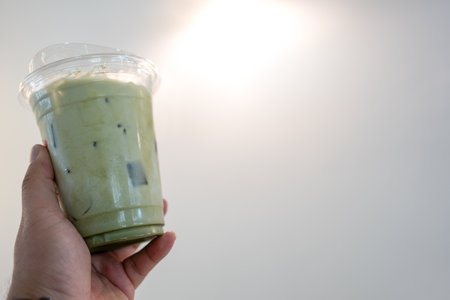 Iced matcha latte green tea on hand.
