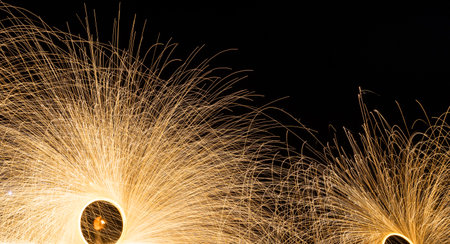 Fire dancers show Swing dancing show fire with flame show on the beach dance man juggling with fire in Thailand.の写真素材