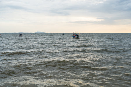 Fishery boat in sea against sky at Bangsaen, Chonburi. Sunset in bangsan beachの写真素材