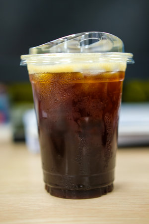 A transparent plastic cup black coffee or iced americano in a cup with a lid at officeの写真素材