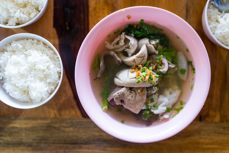 Thai style boiled clear soup with pork entrails, liver in bowl served with rice. Healthy and rich in iron and proteinの写真素材