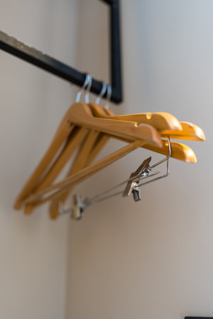 Empty wood hangers on clothes rackの写真素材