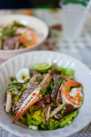 A bowl of dry egg yellow noodle with crawfish, shrimp and crab, sold in Chanthaburi province, Thailandの写真素材