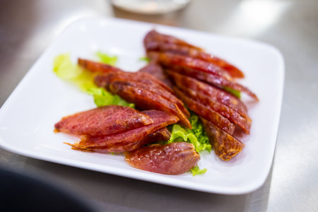 Slice of Chinese and Thai style sausages on with dishの写真素材