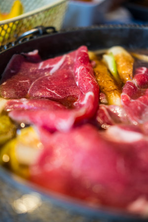 Traditional Sukiyaki pot with raw premium beef and fresh vegetableの写真素材