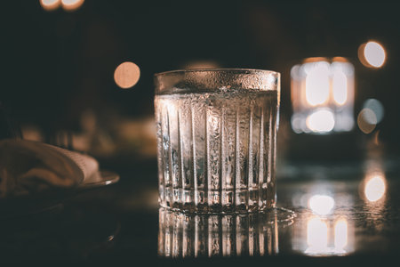 A glass of fresh water at night restaurantの写真素材
