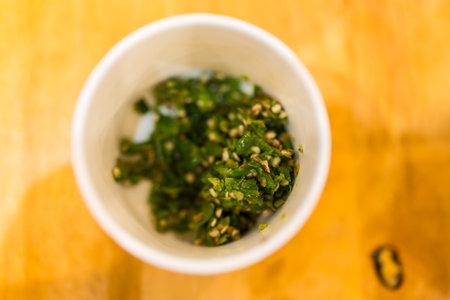 Fresh chopped chili in white bowl for add sukiyaki dip sauce
