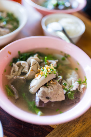 Thai style boiled clear soup with pork entrails and liver in bowl. Healthy and rich in iron and...