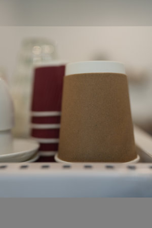 Disposable paper cups for hot drink on coffee machine. The stack of paper cup in the cafeの写真素材