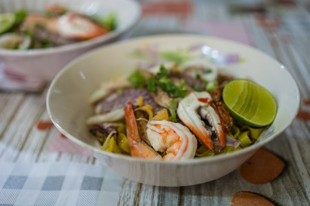 A bowl of special food of dry egg yellow noodle with crawfish, shrimp and crab, sold in Chanthaburi province, Thailandの写真素材
