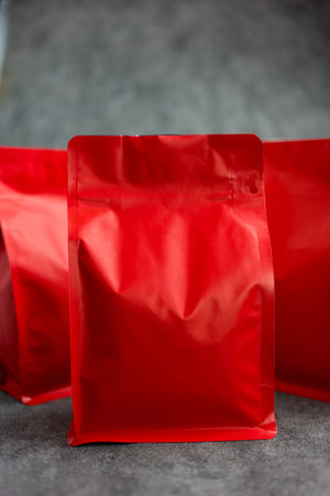 Plastic zip bag packaging for roasted coffee beans. Red sealed coffee bagの写真素材