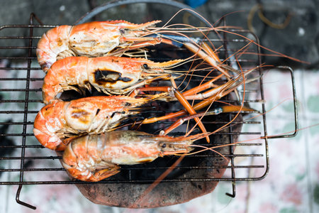Fresh river prawns grilled over charcoal fire at home.の写真素材