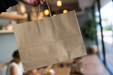 Person holding a paper bag. Shopping bagの写真素材