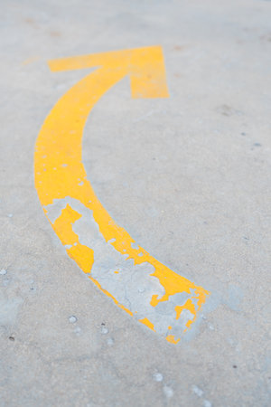 Curved yellow arrow on the road.の写真素材