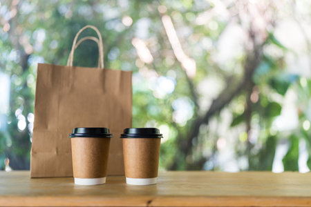 Package of drink delivery on wood table, copy space, your product name placeの写真素材