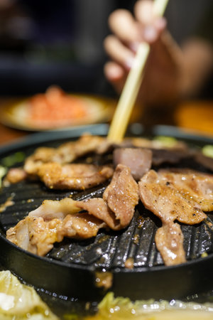 Pork or meat grilling in pan on the stove. Thai barbecue buffet, Asia food, Thai call Moo ka ta. Thailand street food.の写真素材