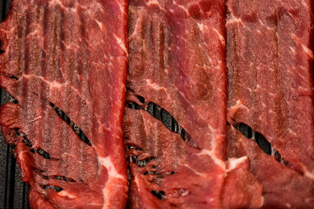 Premium raw beef slice for cooking japanese sukiyaki served on black tray.の写真素材