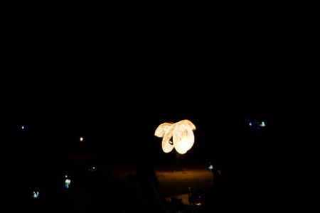 Fire dancers Swing fire dancing show fire show on the beach dance man juggling with fire in Thailandの写真素材