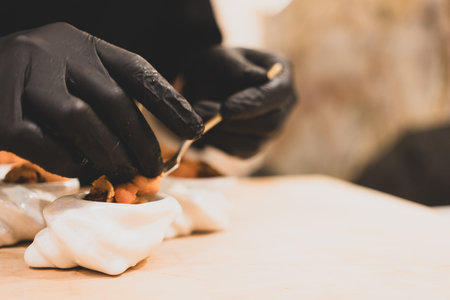 Sushi chef making  uni, sea urchin for customer omakase course in Japanese Omakase in the restaurantの写真素材
