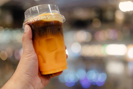Yuzu Americano Orange on hand or Espresso coffee with orange juice drink.の写真素材