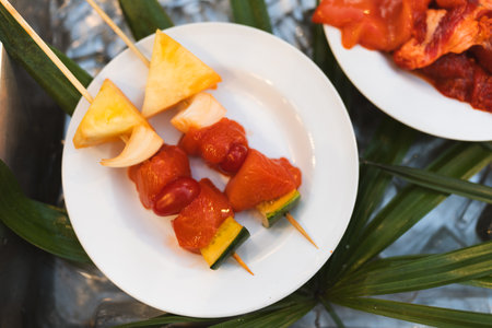 Skewers with chicken meat, and vegetables such as peppers, onions on dish is ready to be put on a barbeque.の写真素材