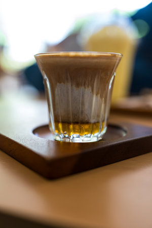 A glass of coffee. Espresso shot on cold milk at cafeの写真素材