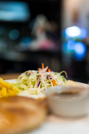 A small salad on a white plate for eating steak on a white plate.の写真素材
