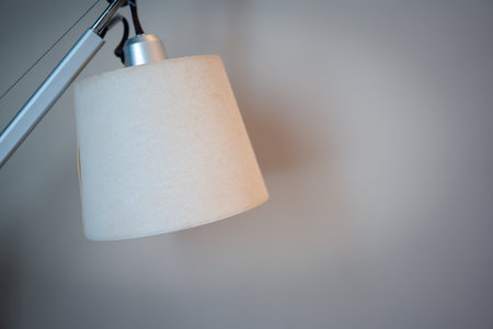Modern white table lamp on a white background, elegance and styleの写真素材