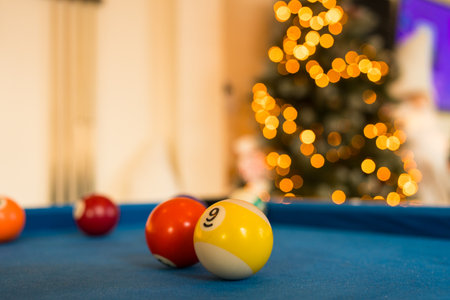 Pool balls on a blue pool table with bokeh backgroundの写真素材