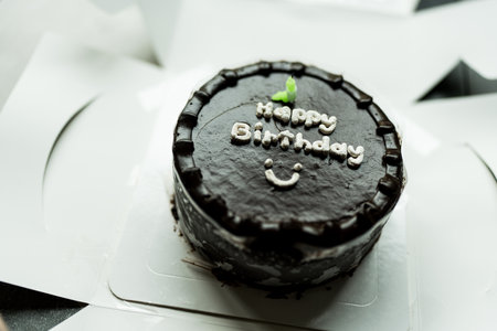 A birthday cake with candle and happy birthday message on topの写真素材
