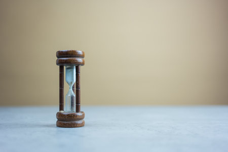 Wood hourglass on a light colour background and copy space for text. Hourglass is also known as sandglass, sand timer or sand clock.の写真素材