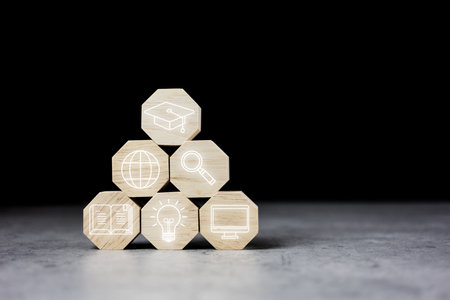 Stacking wood block hexagons with icons of education. The concept of knowledge and success. Diagram of knowledge graduation conceptの写真素材