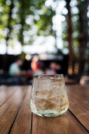 A close up of whiskey mix ice cubes and soda in a glassの写真素材