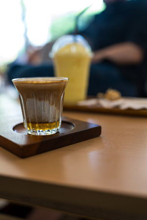 Dirty coffee cup, espresso coffee with milk and honey at cafeの写真素材