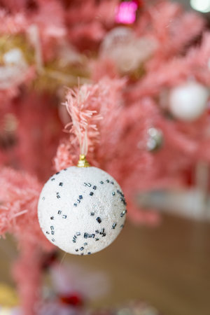 Close up of white ball Christmas decorated on pink Christmas treeの写真素材
