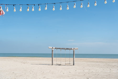 Swing on the beach. Beach vacation summer holiday concept. Luxury romantic travelの写真素材