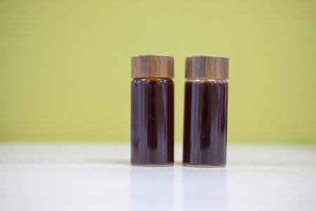 Close up shot of freshly filling a small transparent glass jar.