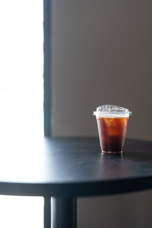 A glass of iced americano black coffee on black table ready to drink in the morning