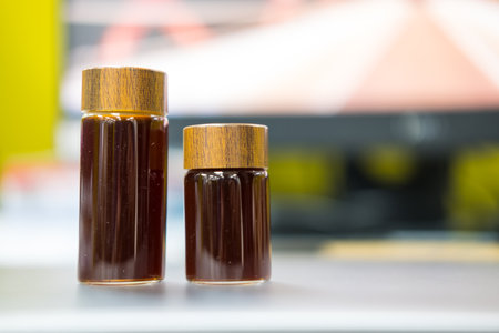 Close up shot of freshly coffee filling a small transparent glass jar.の写真素材