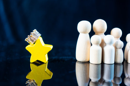 Wood star with crown and wood peg doll. Concept of excellence, acceptance from others, Human resource, Talent management, Recruitment employee. Concept of excellenceの写真素材