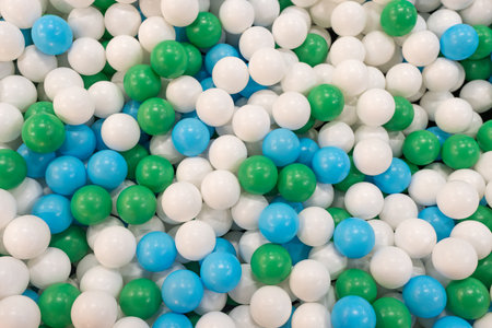 Colored plastic balls (white, green and blue) for a child game at indoor playgroundの写真素材
