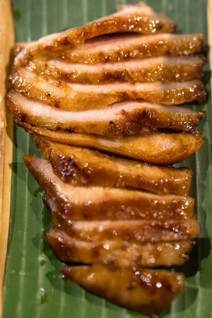 Juicy grilled pork neck served on banana leafの写真素材