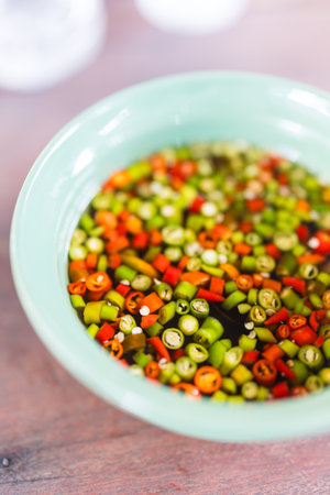 Thai fish sauce three taste. Chili and fish sauce in green ceramic bowlの写真素材