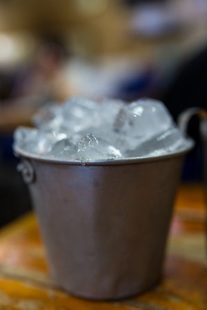 Ice in aluminum tanks on wood tableの写真素材
