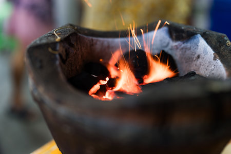 Barbecue flaming charcoal grill with bright flames of fire. Charcoal clay stove thai tradition...