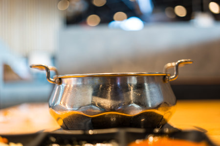 Stainless steel pot prepared for Shabu shabu in restaurant.の写真素材